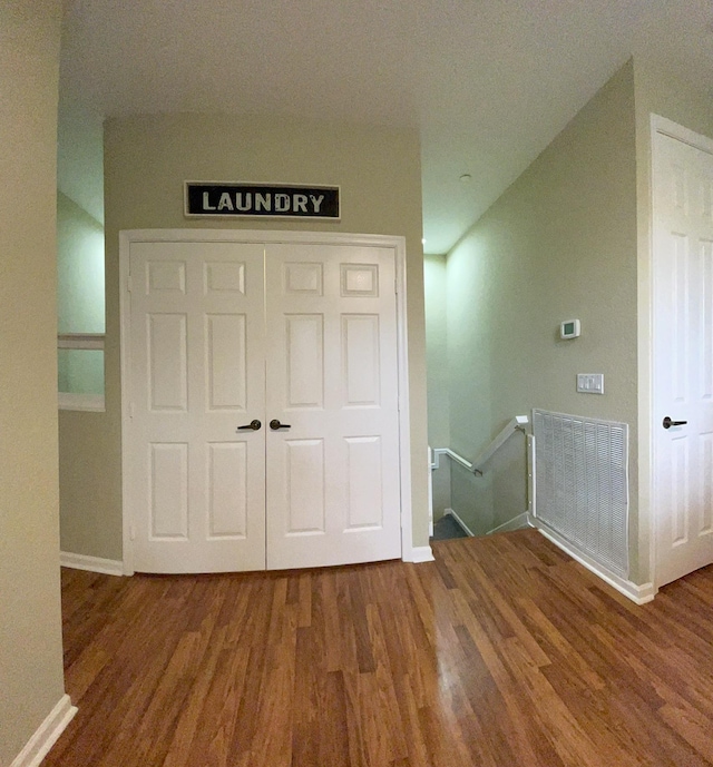 328 SE Bloxham Way, Stuart, FL 34997 - corridor featuring an upstairs landing, wood finished floors, and baseboards