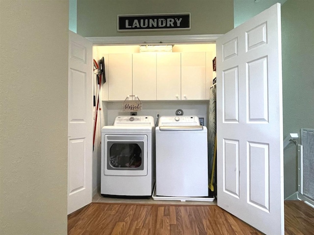 328 SE Bloxham Way, Stuart, FL 34997 - washroom featuring cabinet space, washer and dryer, and wood finished floors