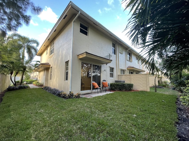 328 SE Bloxham Way, Stuart, FL 34997 - back of house with stucco siding and a patio