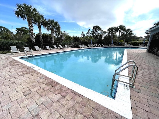 328 SE Bloxham Way, Stuart, FL 34997 - community pool featuring a patio and view of scattered trees