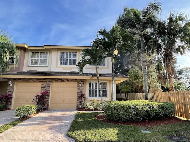 328 SE Bloxham Way, Stuart, FL 34997 - multi unit property featuring stucco siding, decorative driveway, an attached garage, and stone siding