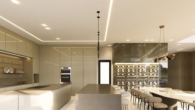 interior space featuring a spacious island, decorative light fixtures, and double oven