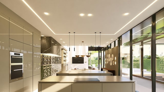 kitchen with modern cabinets, black electric cooktop, stainless steel double oven, and decorative light fixtures