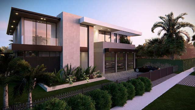 back house at dusk featuring a balcony