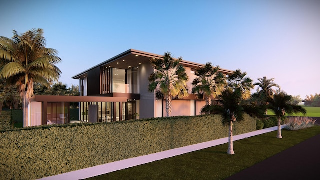 view of front of property with a yard and a balcony