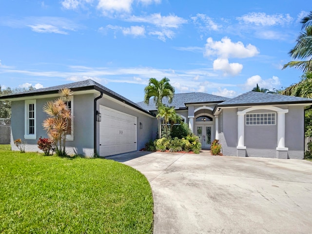 ranch-style home with a garage and a front lawn