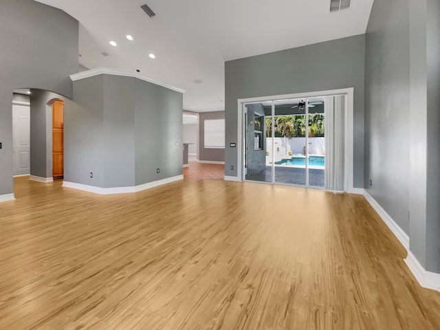 unfurnished living room featuring light hardwood / wood-style flooring and lofted ceiling