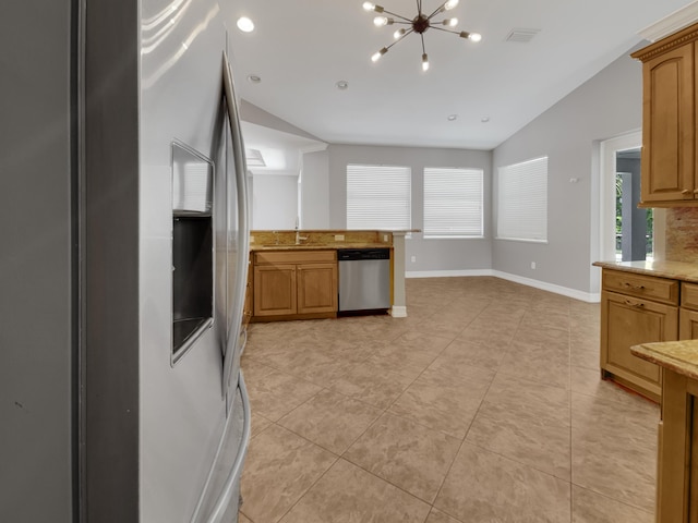 kitchen with vaulted ceiling, stainless steel appliances, a chandelier, and light tile patterned floors