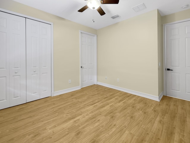 unfurnished bedroom featuring ceiling fan, a closet, and light hardwood / wood-style floors