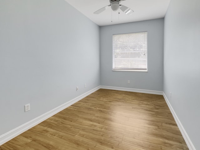 empty room with ceiling fan and light hardwood / wood-style flooring