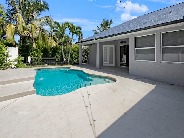 view of pool with ceiling fan and a patio