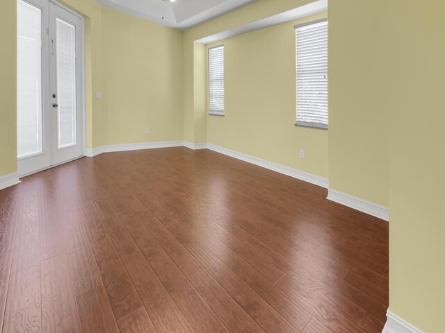 unfurnished room with hardwood / wood-style floors