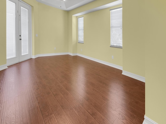 spare room featuring french doors, hardwood / wood-style floors, and ceiling fan