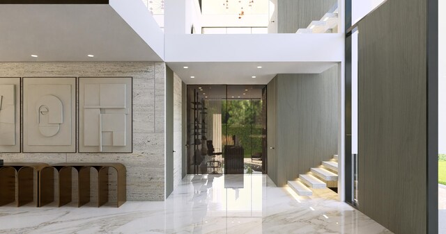 foyer featuring stairway, marble finish floor, and a high ceiling