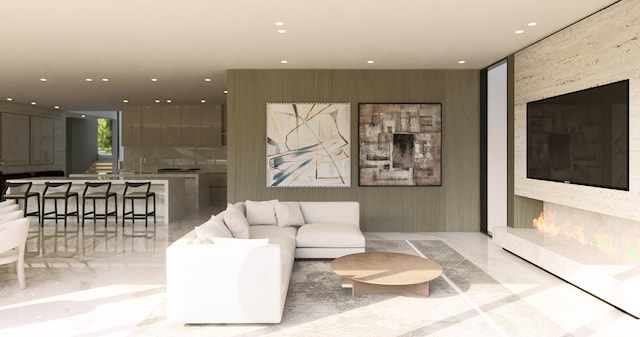 living area with recessed lighting and marble finish floor
