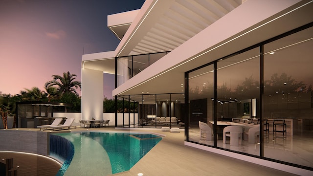 pool at twilight with a patio area and a fenced in pool