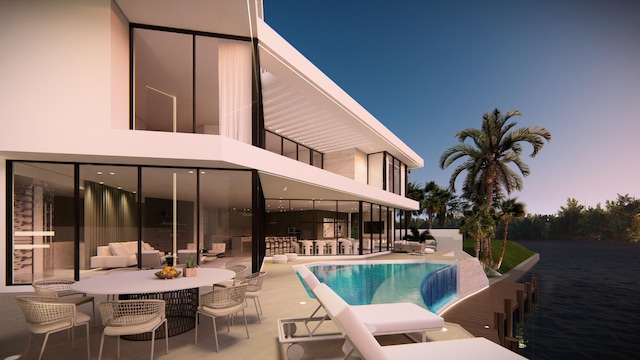 pool with a patio area and outdoor dining area