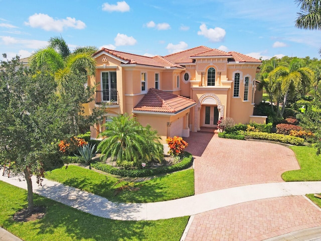 mediterranean / spanish home with a front lawn