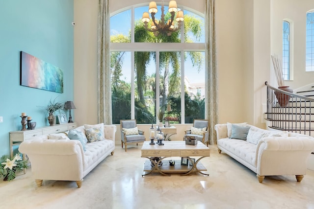 living room featuring a towering ceiling and a notable chandelier