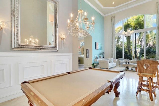 rec room featuring crown molding, light tile patterned flooring, pool table, and a towering ceiling