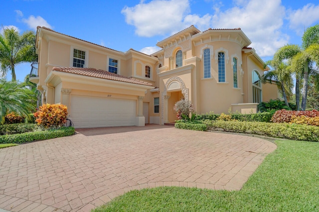 mediterranean / spanish-style home with a garage