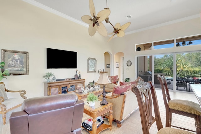 living room with ceiling fan, crown molding, and light wood-type flooring