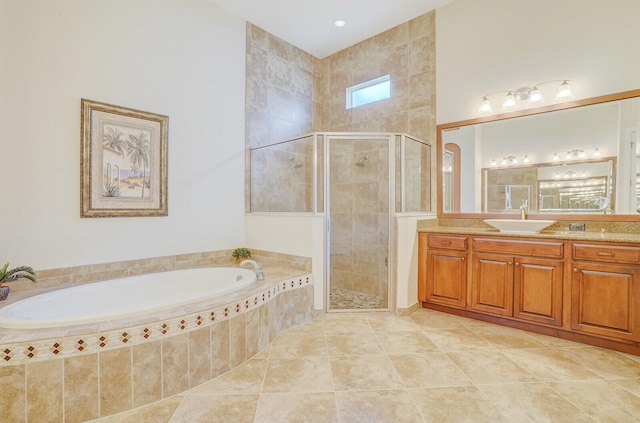 bathroom featuring plus walk in shower, tile patterned floors, and vanity