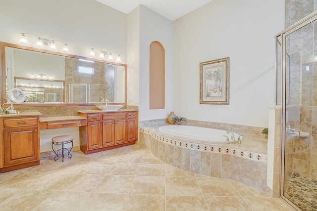 bathroom with tile patterned flooring, separate shower and tub, and vanity