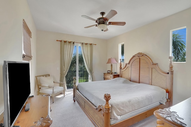 bedroom with ceiling fan, access to exterior, and light carpet