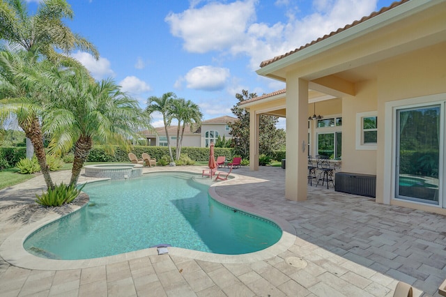 view of swimming pool featuring an in ground hot tub and a patio