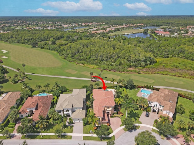 birds eye view of property featuring golf course view, a water view, and a residential view