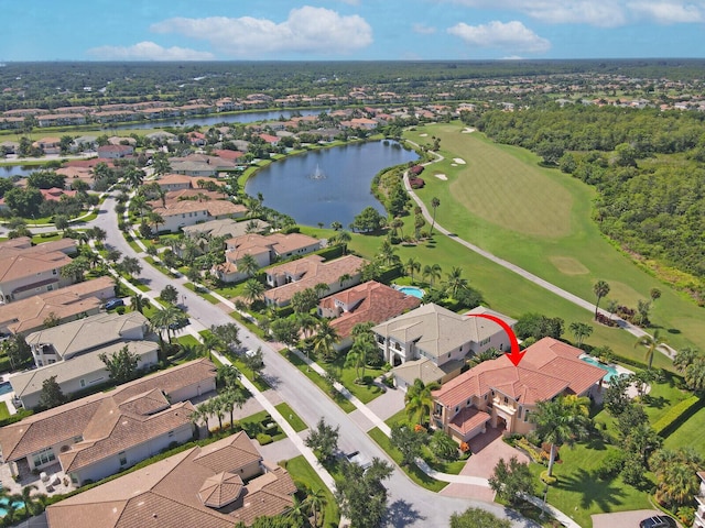 aerial view with a residential view, a water view, and golf course view