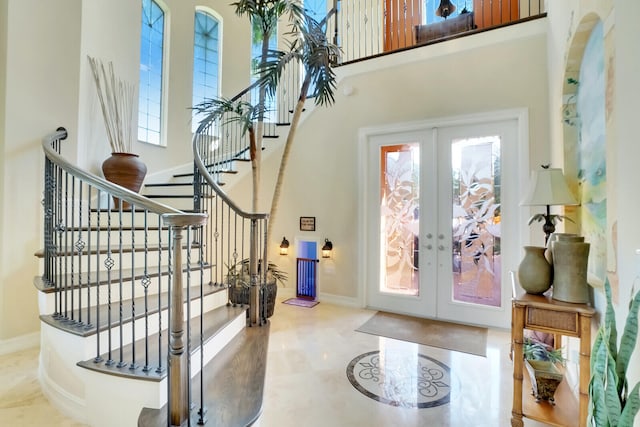 tiled entrance foyer with french doors and a high ceiling