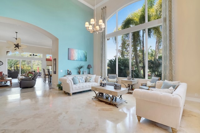 living room featuring a wealth of natural light, ornamental molding, a towering ceiling, and light tile patterned floors