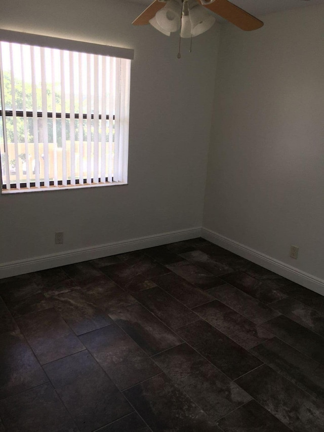 tiled empty room with ceiling fan