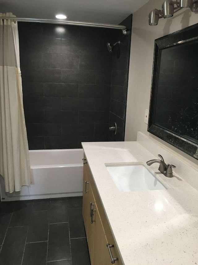 bathroom featuring tile patterned flooring, shower / tub combo with curtain, and vanity