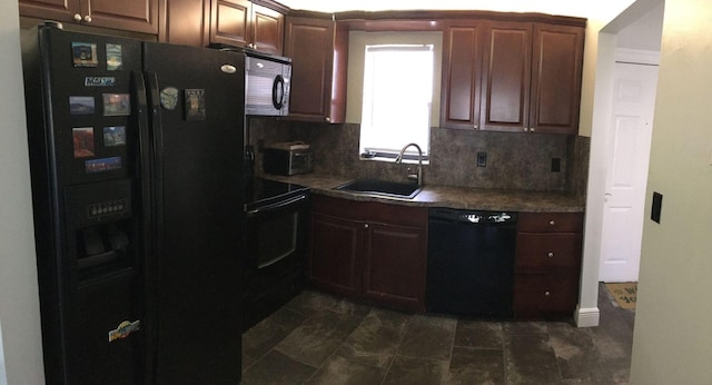 kitchen featuring sink, tasteful backsplash, dark tile patterned floors, and black appliances