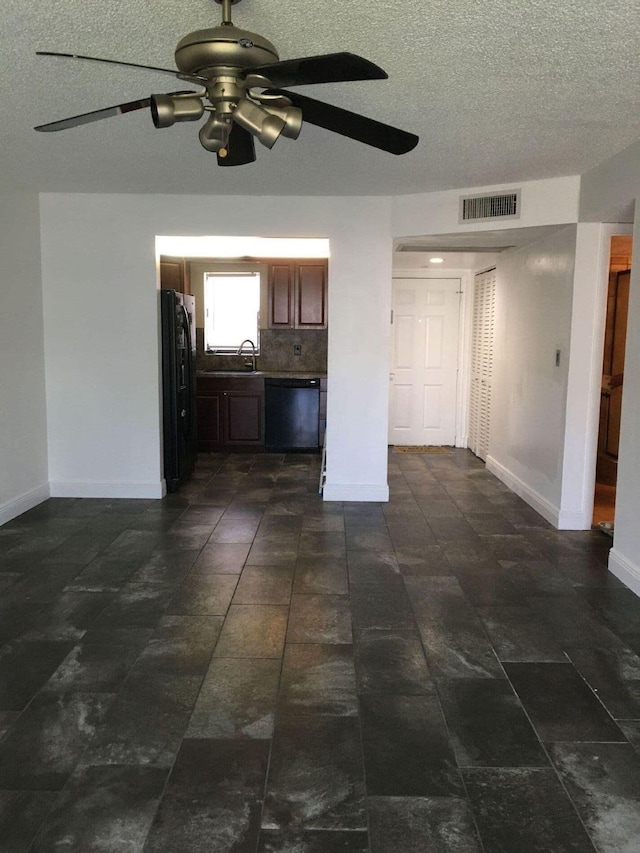 interior space with ceiling fan, sink, and dark tile patterned floors