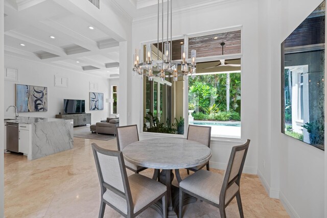 tiled dining space featuring beamed ceiling, coffered ceiling, ornamental molding, sink, and an inviting chandelier