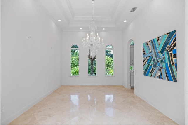 tiled empty room featuring an inviting chandelier, ornamental molding, and a tray ceiling