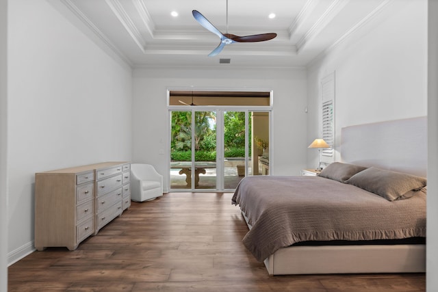 bedroom with ornamental molding, access to outside, wood-type flooring, a tray ceiling, and ceiling fan