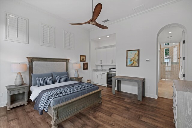 bedroom with crown molding, wine cooler, dark hardwood / wood-style flooring, ensuite bath, and ceiling fan