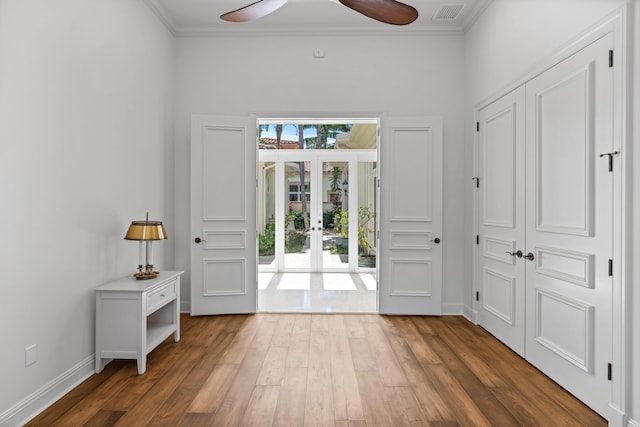 entryway featuring ceiling fan, ornamental molding, and dark hardwood / wood-style floors