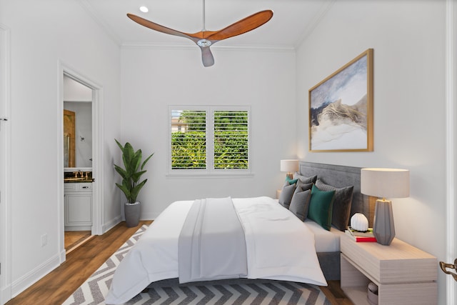 bedroom featuring ceiling fan, dark hardwood / wood-style flooring, ornamental molding, ensuite bath, and sink