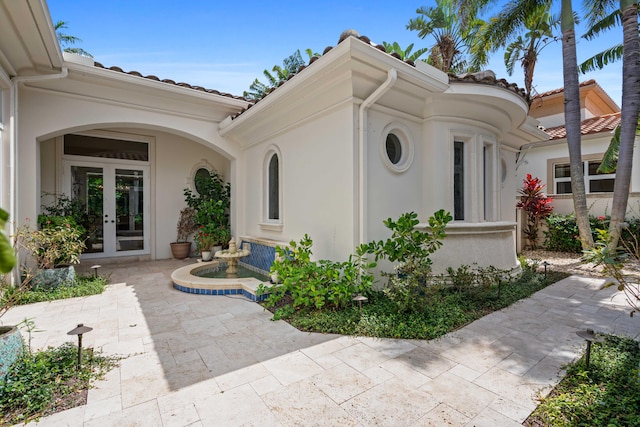 entrance to property with a patio and french doors