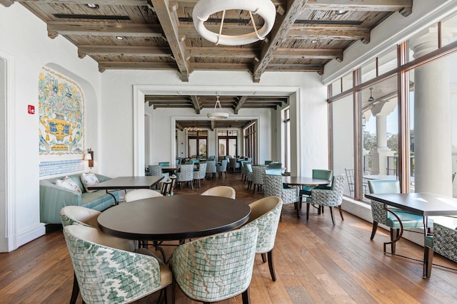 dining room with beam ceiling, wooden ceiling, and hardwood / wood-style floors