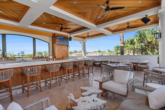 view of patio with ceiling fan and exterior bar