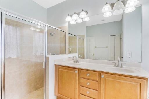 bathroom with an enclosed shower and vanity