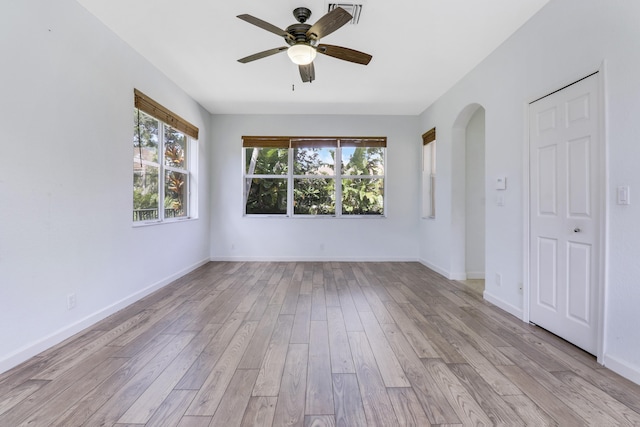 unfurnished room with light wood-type flooring and ceiling fan