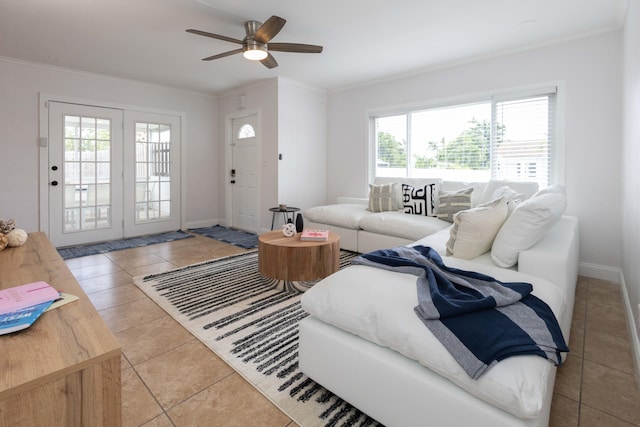 tiled living room with ceiling fan and ornamental molding